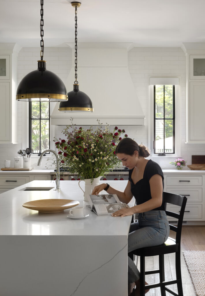 A woman reading a magazine in a Brush Arbor Homes kitchen.